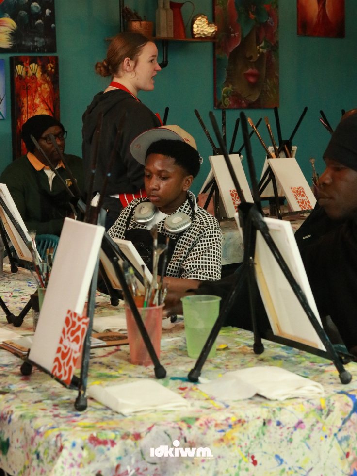 Men painting together at tables
